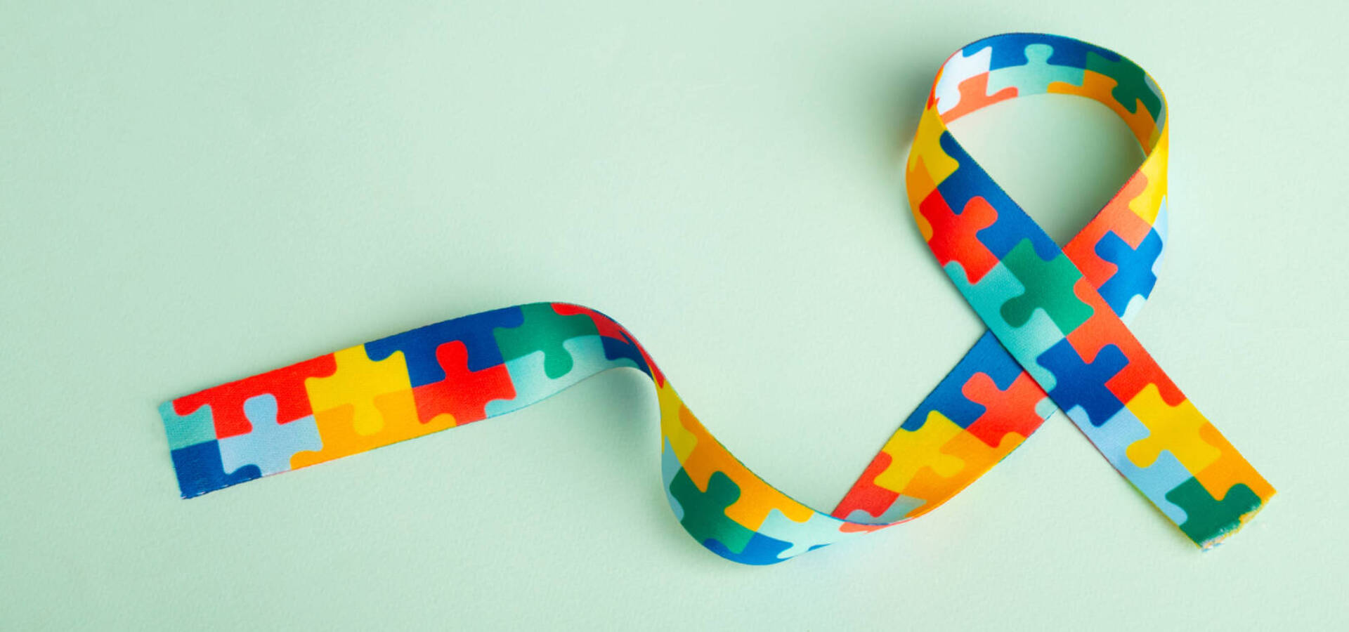 World Autism awareness and pride day with Puzzle pattern ribbon