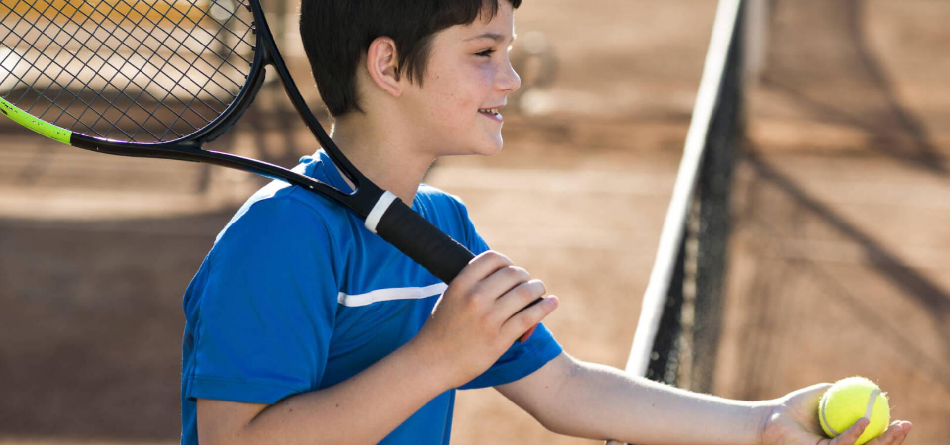 sideways-kid-showing-tennis-ball